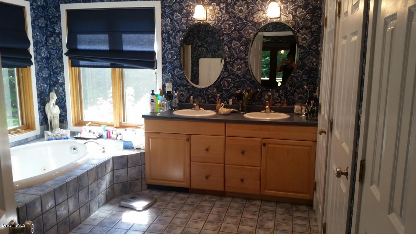 116 Otis Road Becket, MA 01223 - Photo 15 of 29 a bathroom with a tub sink and mirror