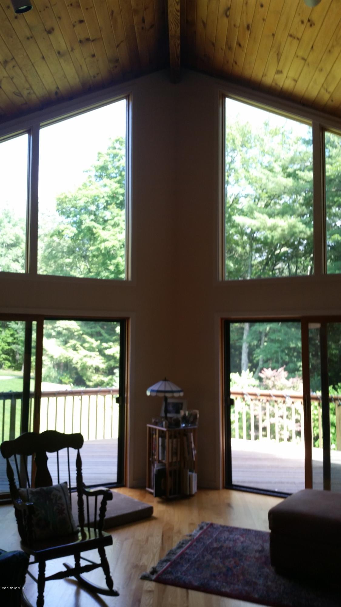 116 Otis Road Becket, MA 01223 - Photo 17 of 29 a living room with furniture and a floor to ceiling window