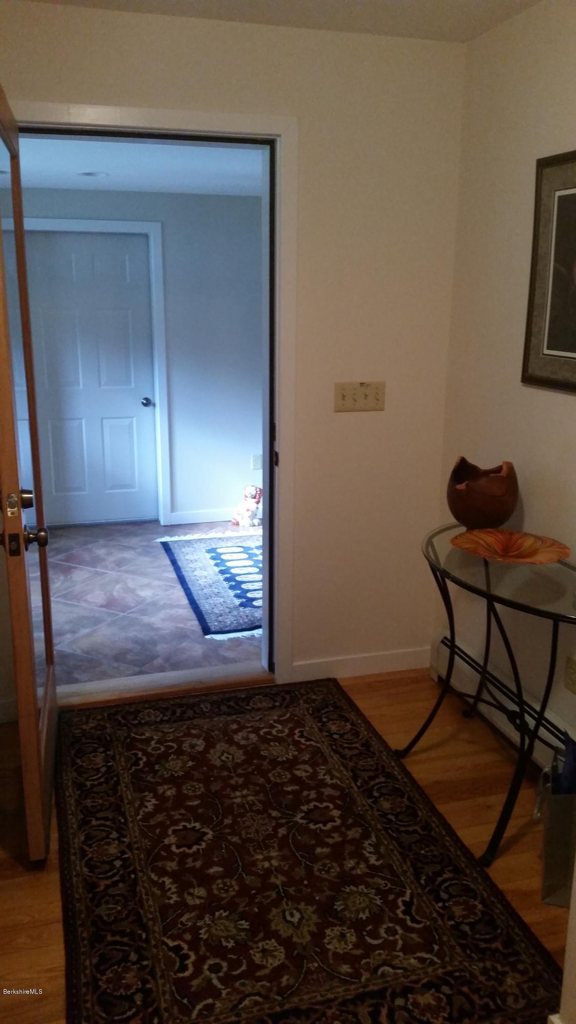 116 Otis Road Becket, MA 01223 - Photo 19 of 29 a room that has a rug and a chair in it