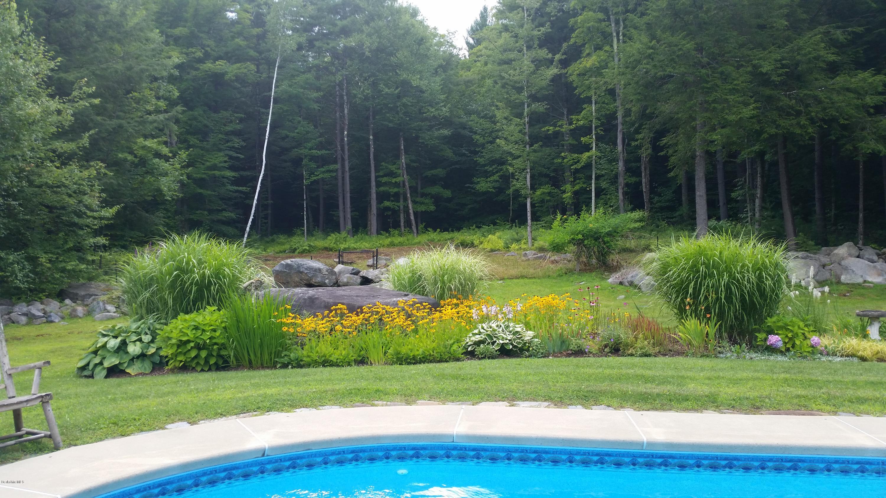 116 Otis Road Becket, MA 01223 - Photo 26 of 29 a view of a garden with a wooden fence