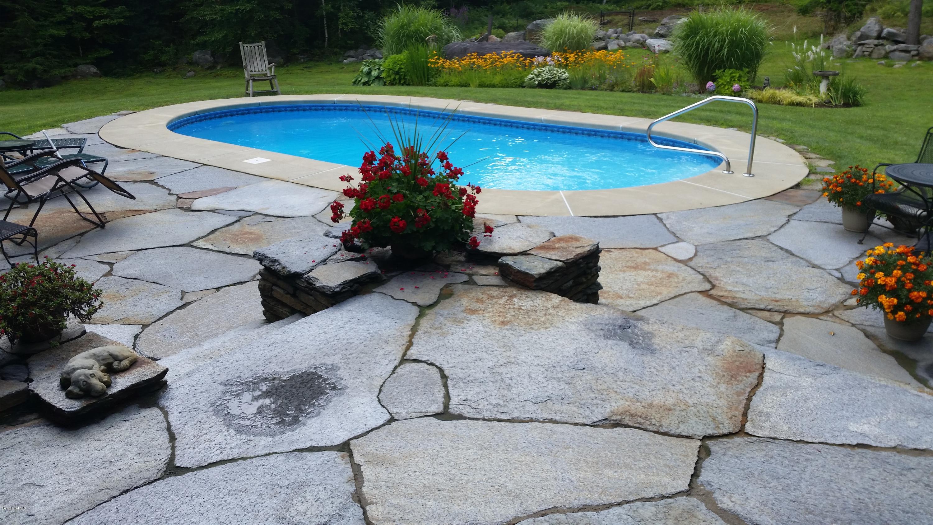 116 Otis Road Becket, MA 01223 - Photo 4 of 29 a view of a swimming pool and lounge chairs in back yard