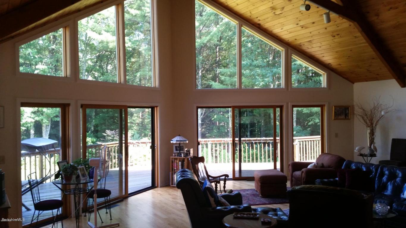 116 Otis Road Becket, MA 01223 - Photo 5 of 29 a living room with furniture tv and large windows