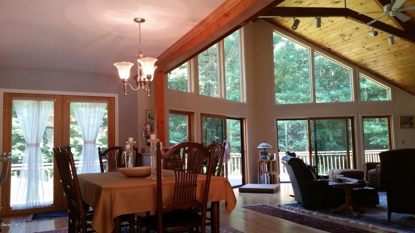 116 Otis Road Becket, MA 01223 - Photo 6 of 29 a view of a dining room with furniture large windows and wooden floor