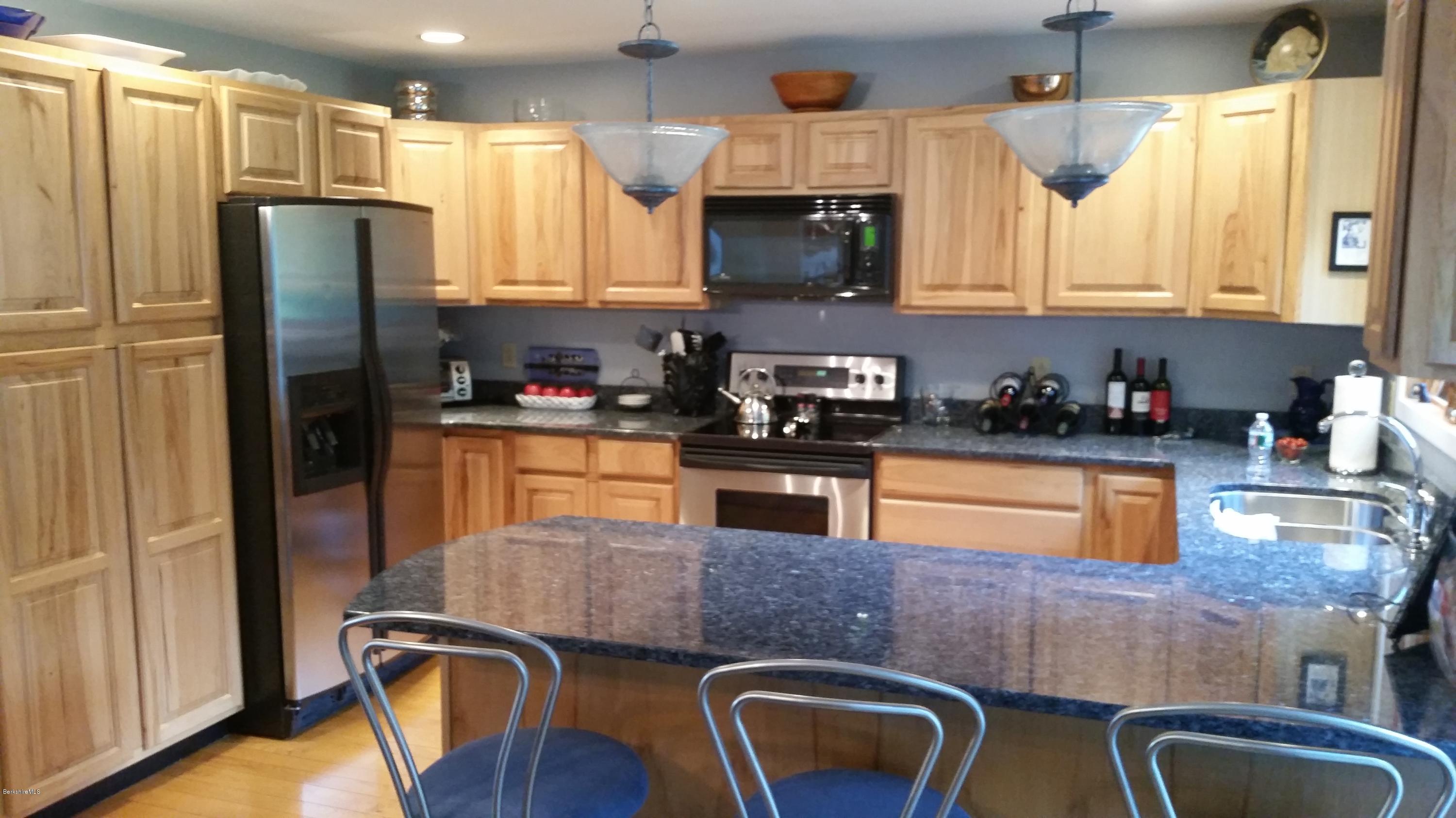 116 Otis Road Becket, MA 01223 - Photo 8 of 29 a kitchen with stainless steel appliances granite countertop a refrigerator stove top oven a sink and dishwasher
