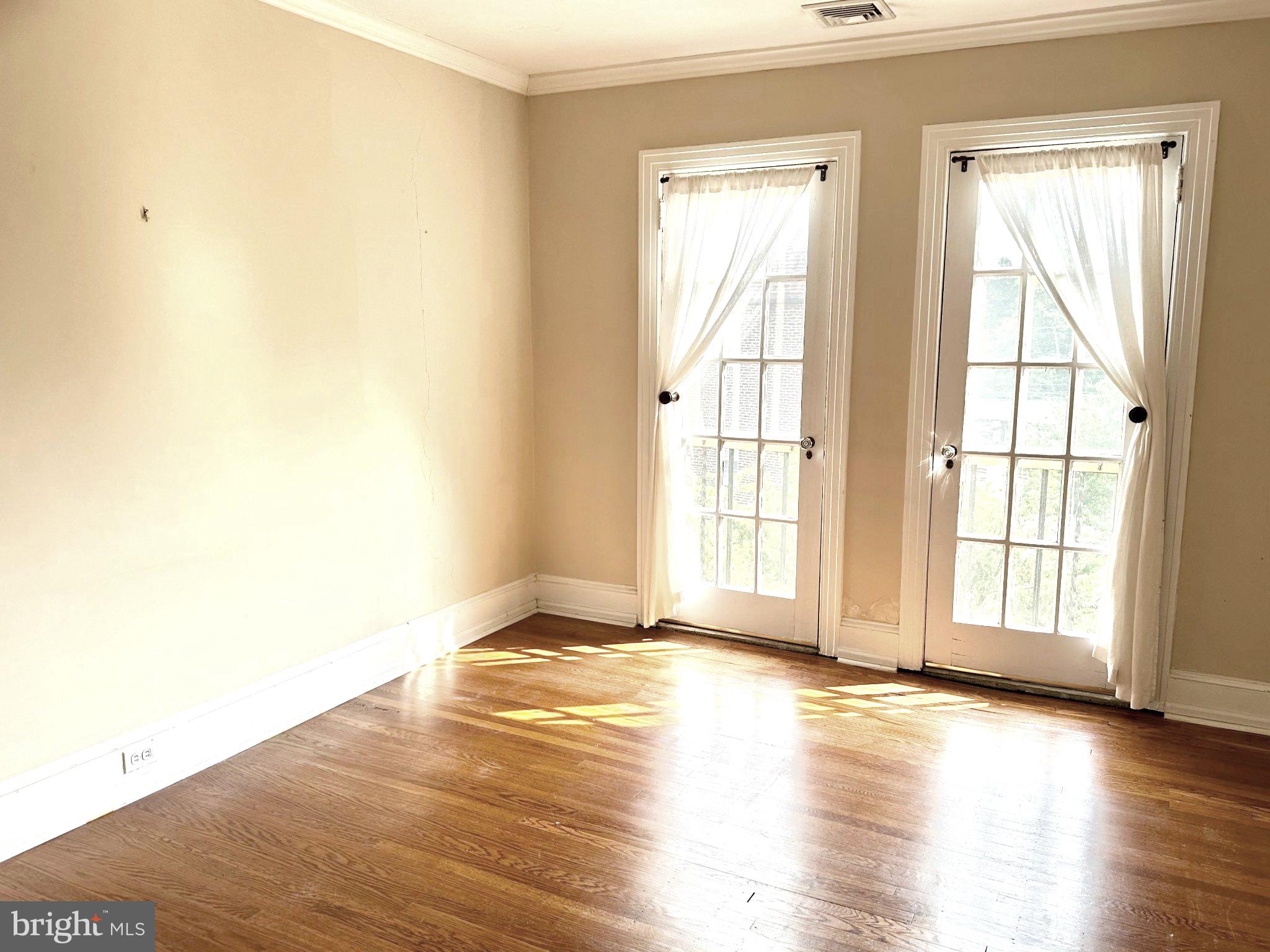 212 Idris Road, Unit F3 Merion Station, PA 19066 - Photo 15 of 25 Sunlit bedroom original, elegant French doors.