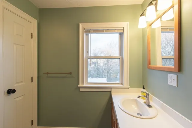 a bathroom with a sink and a window