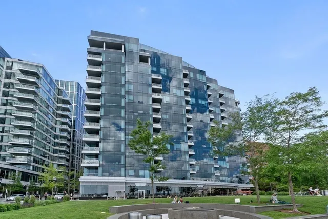 a front view of a building with trees