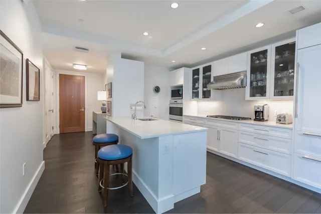 a large kitchen with stainless steel appliances kitchen island a large counter space a sink and a refrigerator