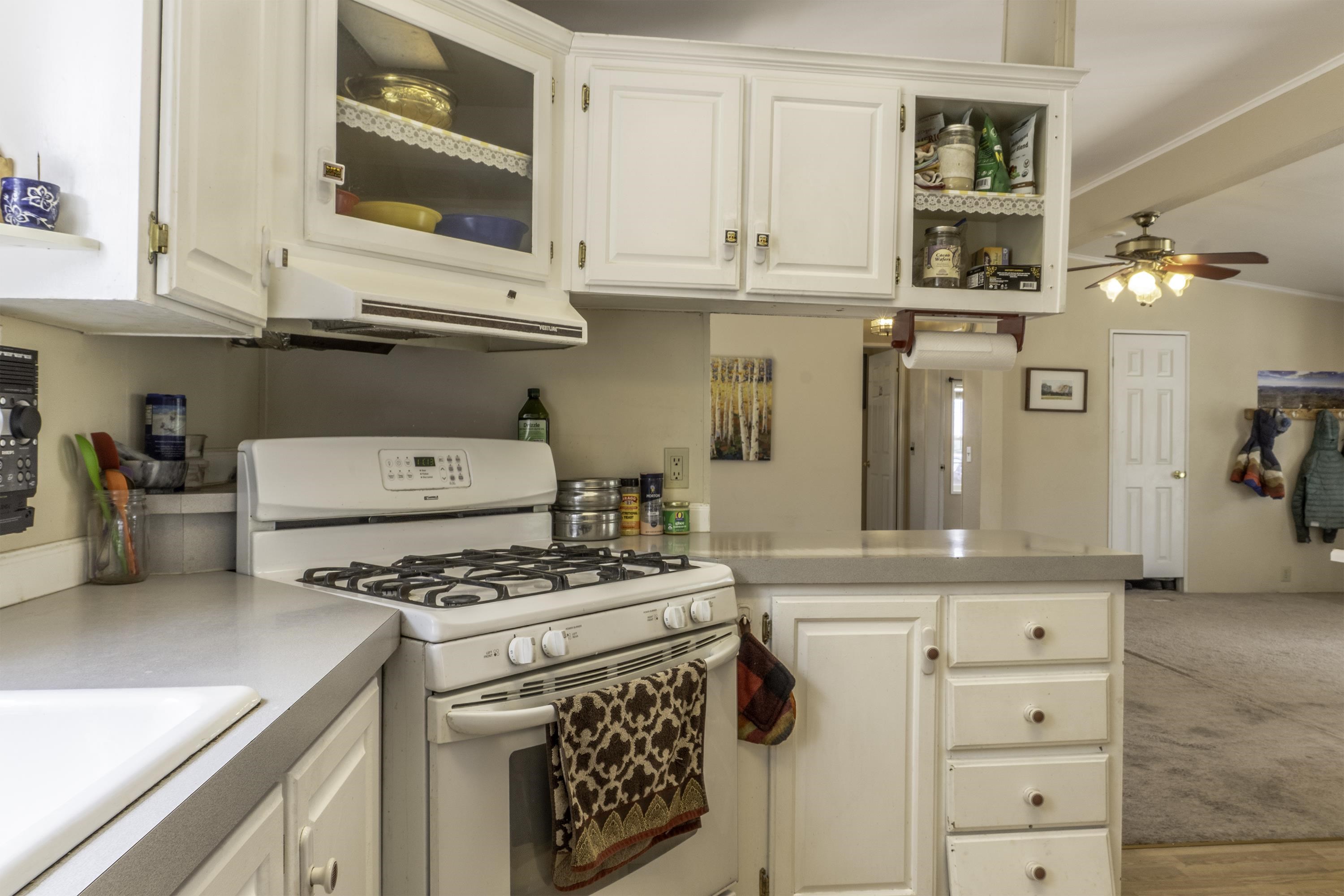 18 Eagle-Peak Bridgeport, CA 93517 - Photo 11 of 45 a kitchen with stainless steel appliances granite countertop a stove and a microwave
