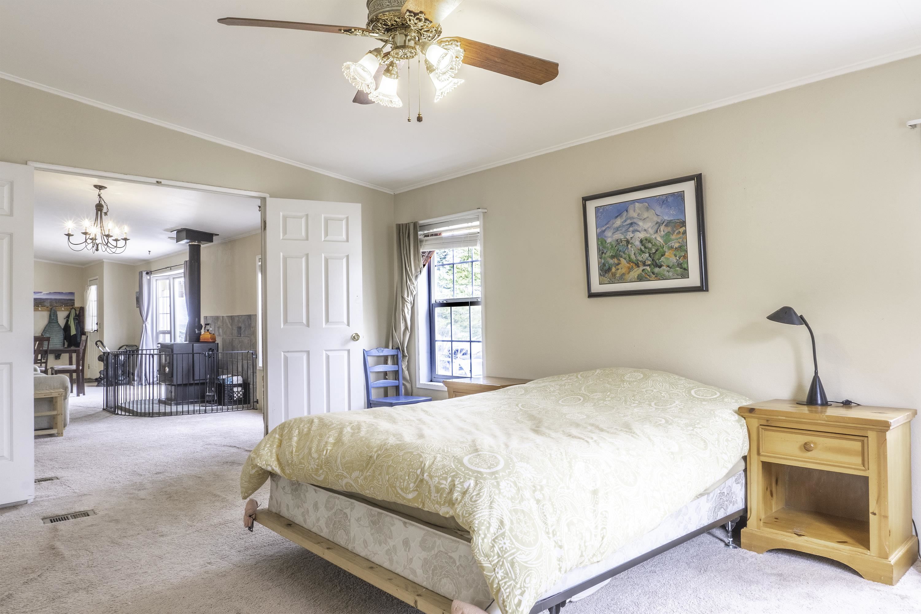 18 Eagle-Peak Bridgeport, CA 93517 - Photo 14 of 45 a bedroom with a large bed and a chandelier