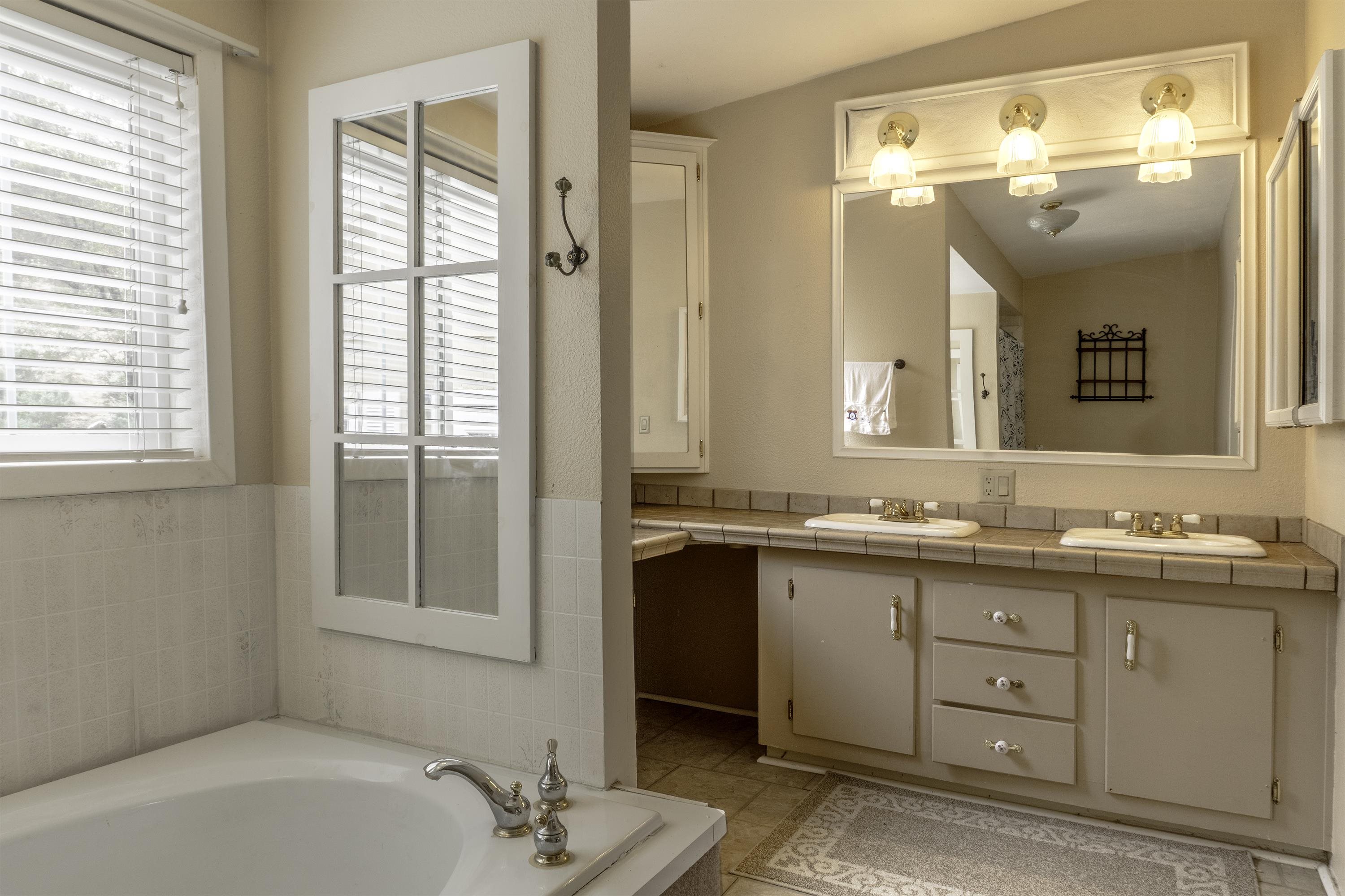 18 Eagle-Peak Bridgeport, CA 93517 - Photo 17 of 45 a bathroom with a tub a sink and a mirror