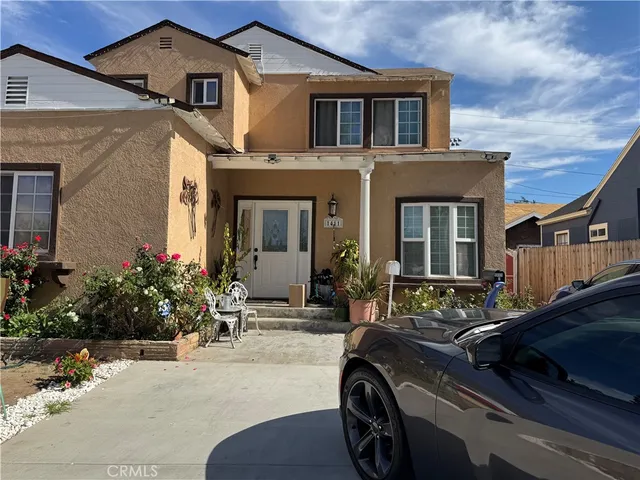a car parked in front of a white house