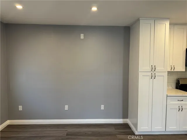 a view of a livingroom with racks on the wall