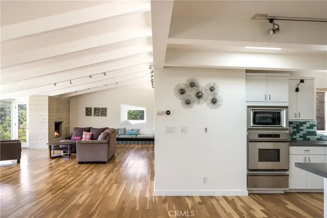 a living room with furniture and kitchen view