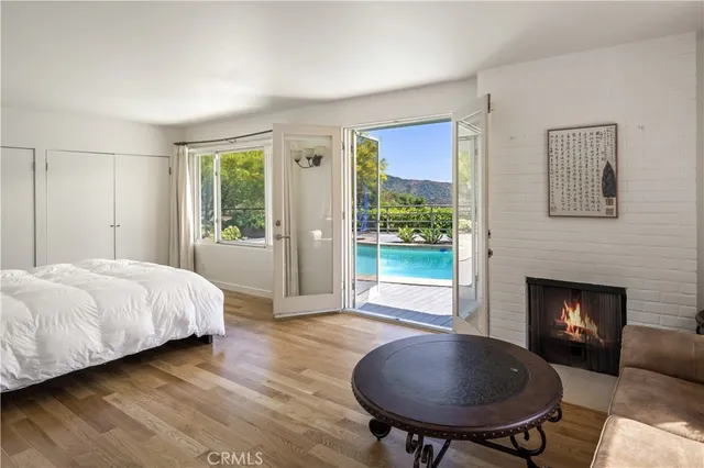 a spacious bedroom with a bed and a fireplace