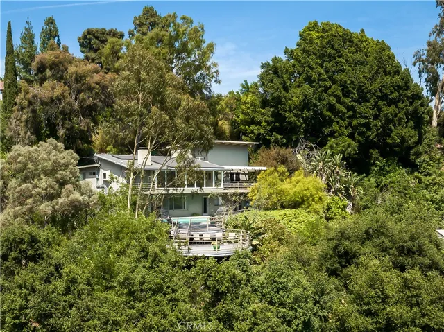 a aerial view of a house with a yard basket ball court and outdoor seating