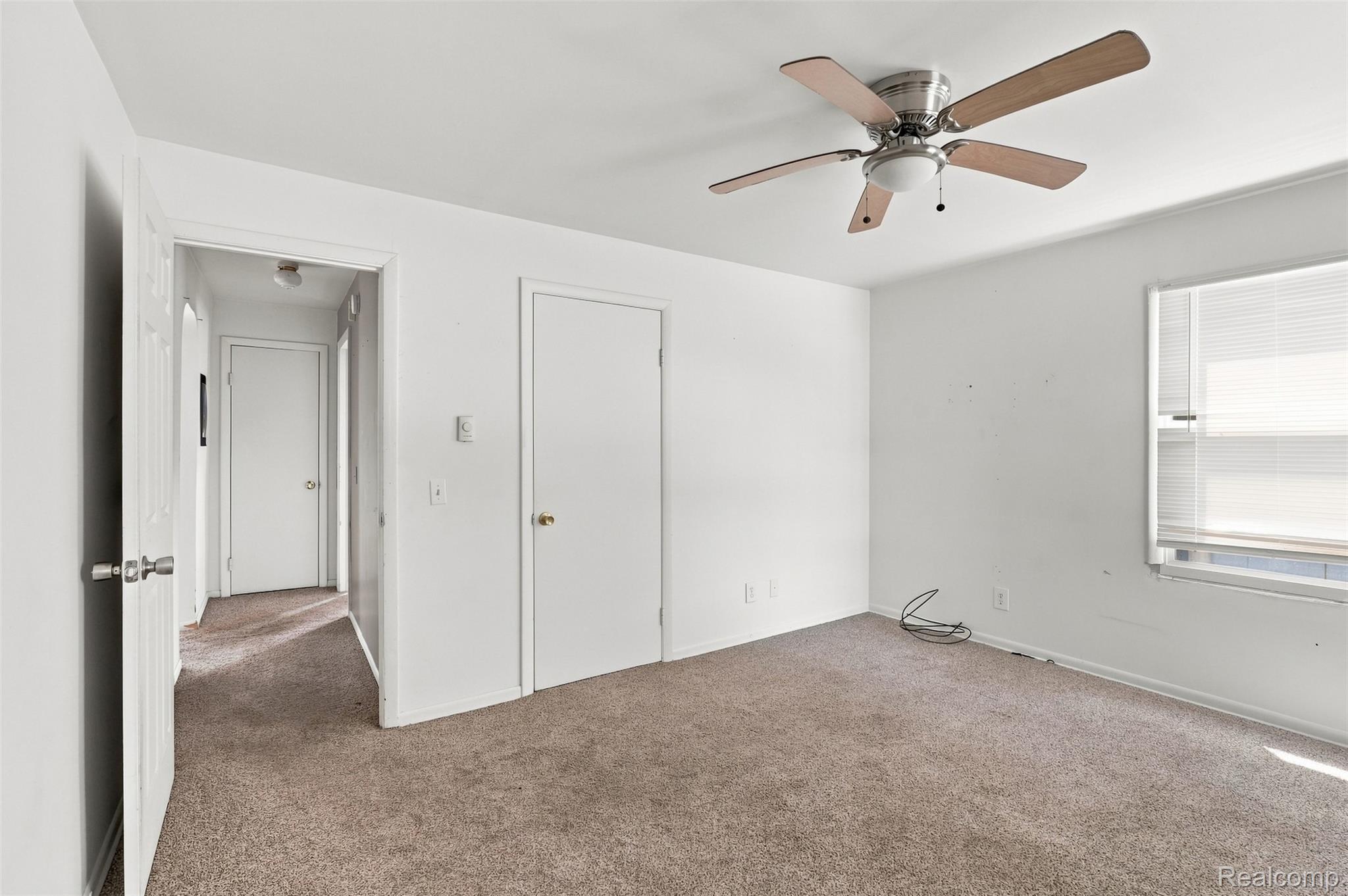 5161 Parker Road Fort Gratiot, MI 48059 - Photo 20 of 64 Carpeted room featuring a ceiling fan with integrated lighting, a window with horizontal blinds, and a white interior door
