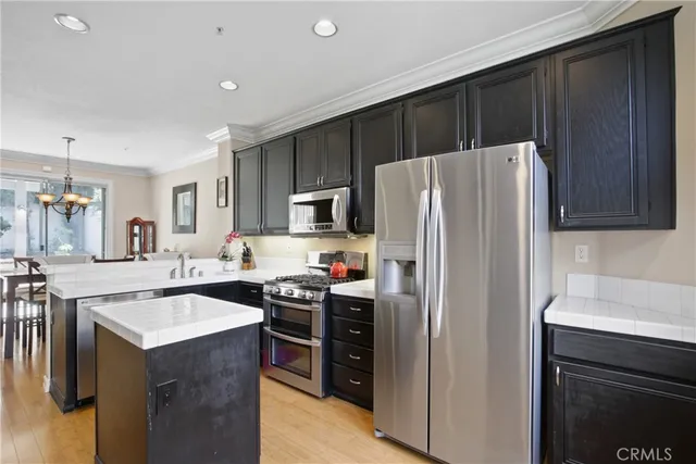 a kitchen with kitchen island a sink stove and refrigerator