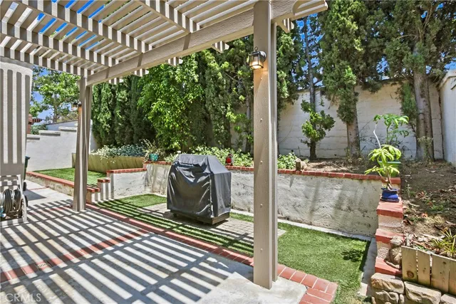 a view of a porch with furniture and garden