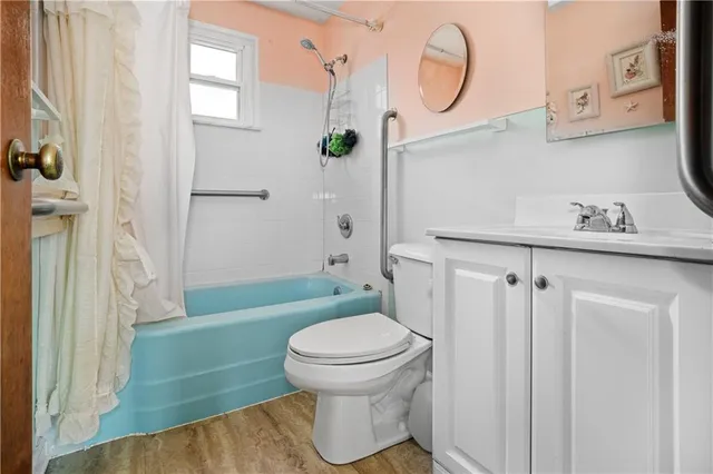 a bathroom with a toilet sink and shower