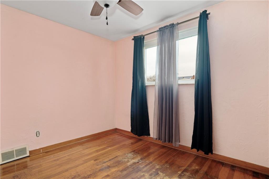 217 Mifflin Street Homestead, PA 15120 - Photo 16 of 26 an empty room with wooden floor and windows