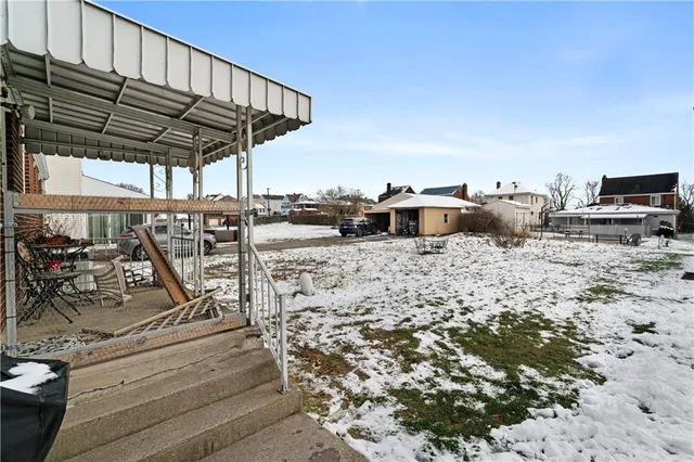 a view of a patio with a table and chairs