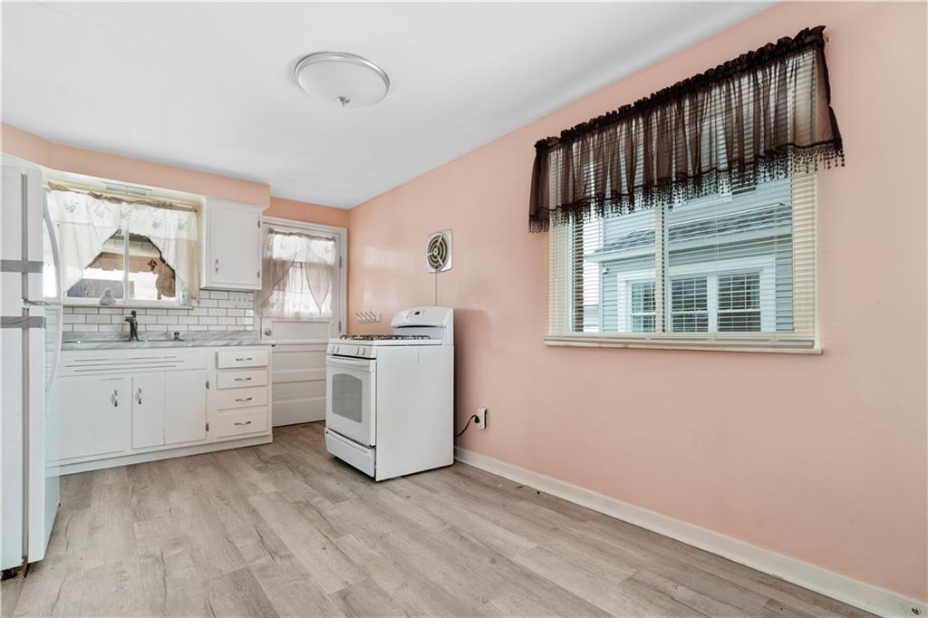 217 Mifflin Street Homestead, PA 15120 - Photo 9 of 26 a kitchen with white cabinets and white appliances