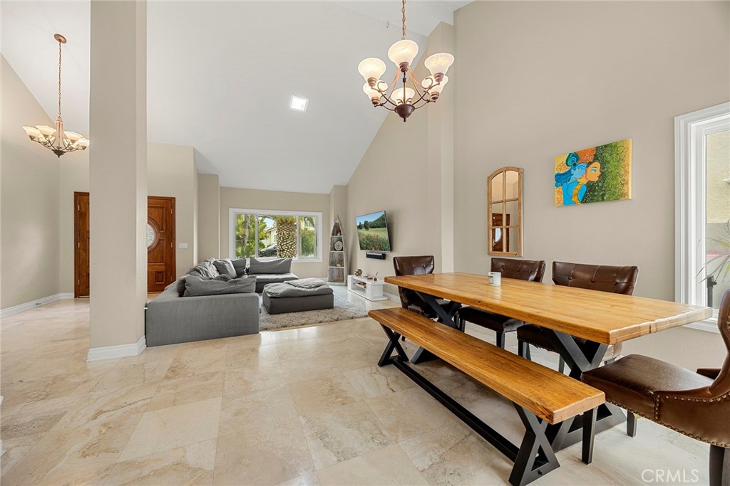 6 Sand Pointe Laguna Niguel, CA 92677 - Photo 15 of 49 a spacious bedroom with a bed and a chandelier