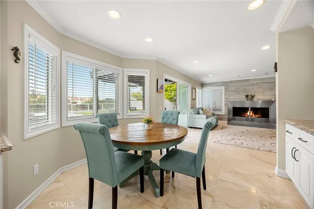 a kitchen with granite countertop white cabinets and stainless steel appliances