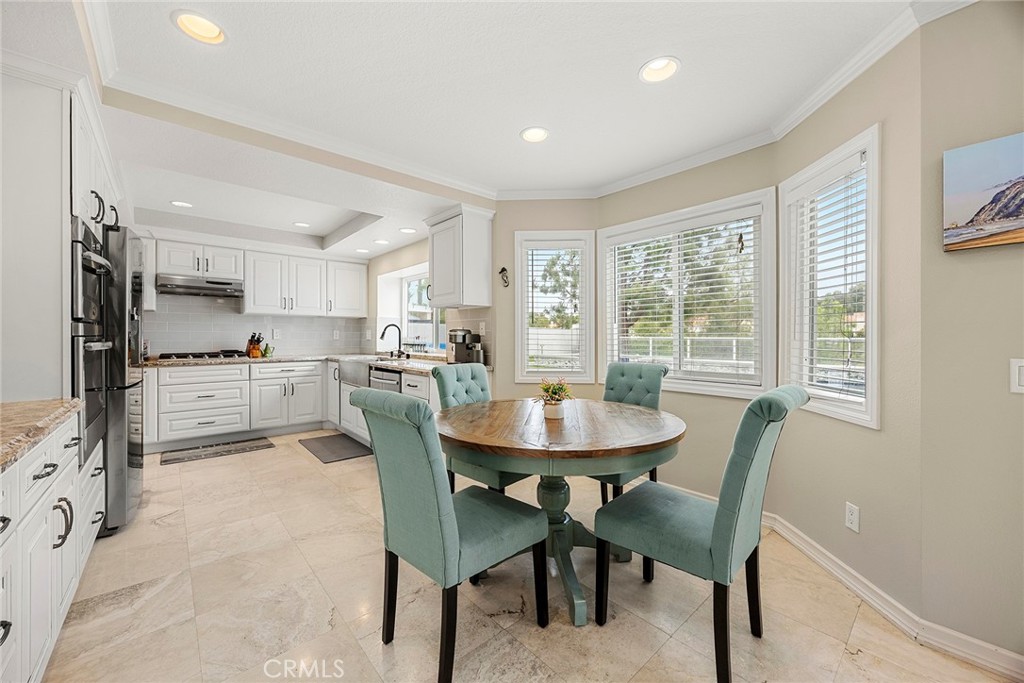 6 Sand Pointe Laguna Niguel, CA 92677 - Photo 21 of 49 a kitchen with stainless steel appliances kitchen island granite countertop a dining table chairs and granite counter tops