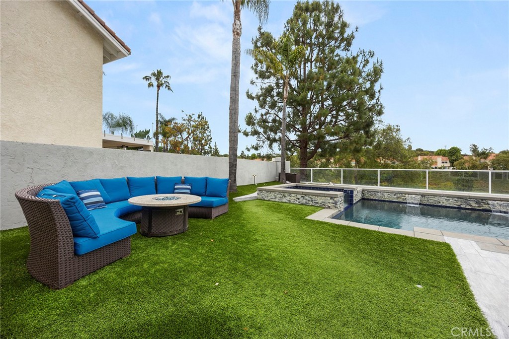 6 Sand Pointe Laguna Niguel, CA 92677 - Photo 40 of 49 a view of a swimming pool with a bench and trees in the background