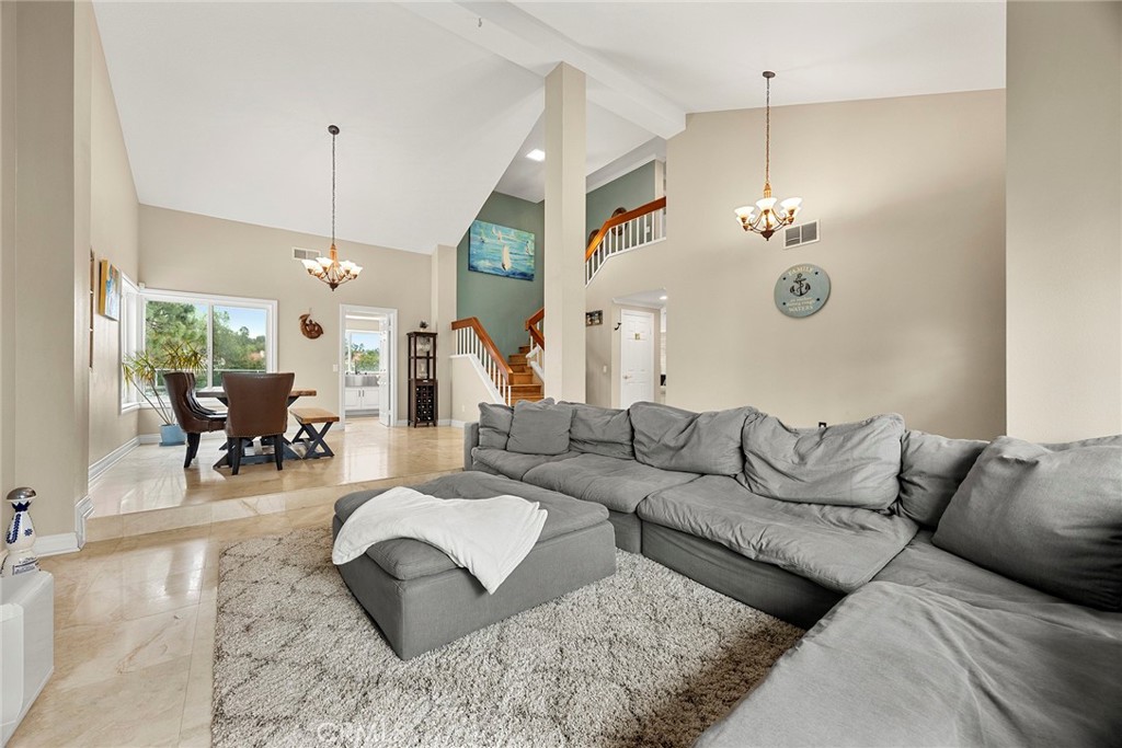 6 Sand Pointe Laguna Niguel, CA 92677 - Photo 4 of 49 a living room with furniture and a chandelier