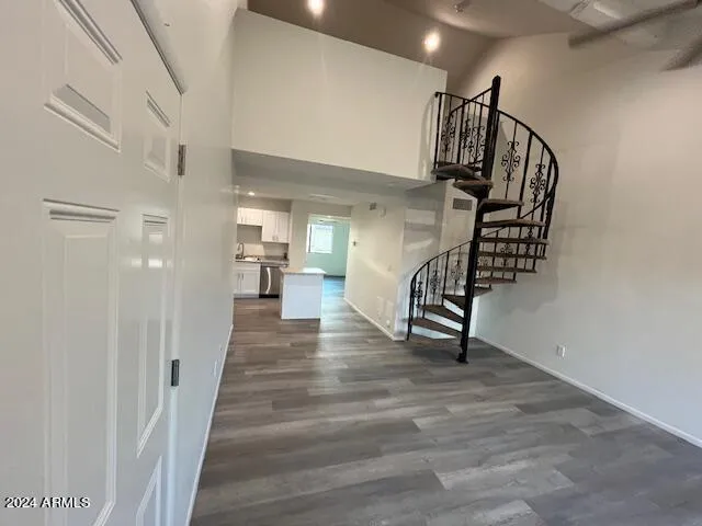 a view of entryway and hall with wooden floor