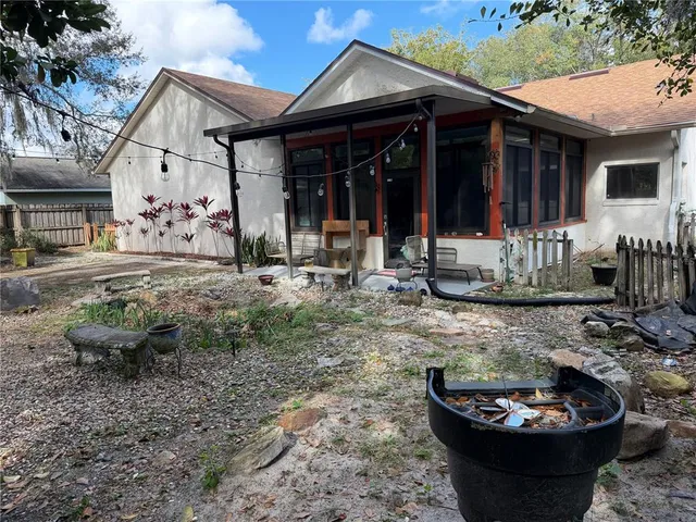 a view of a large yard with a tree