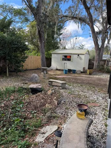 a view of a backyard with plants and trees