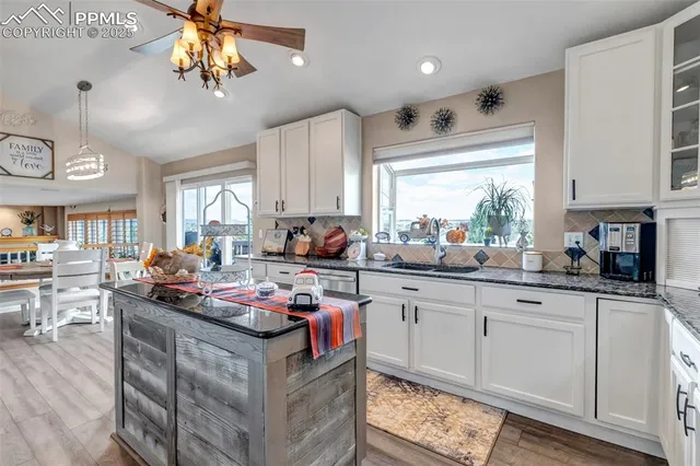 a kitchen with stainless steel appliances granite countertop a sink stove and cabinets