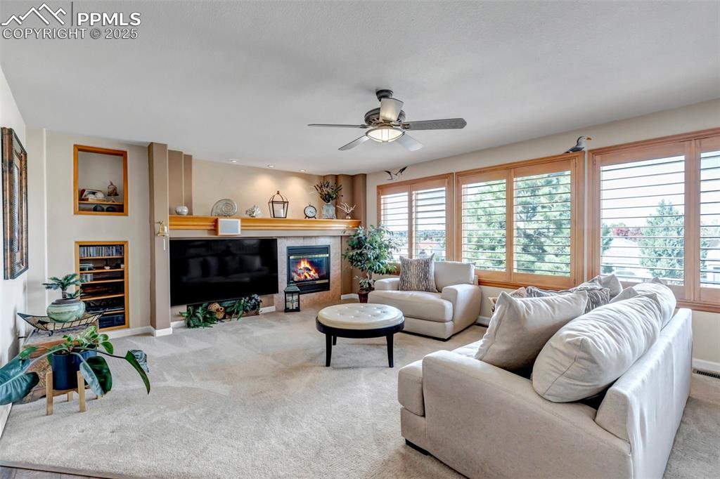 7120 Highcroft Drive Colorado Springs, CO 80922 - Photo 20 of 50 a living room with furniture a fireplace and a large window