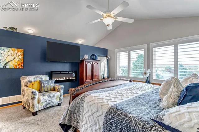 a bed room with furniture and a flat screen tv