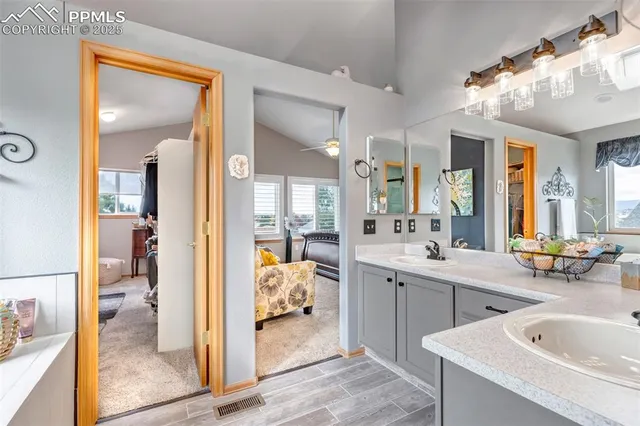 a large bathroom with a tub sink shower and mirror
