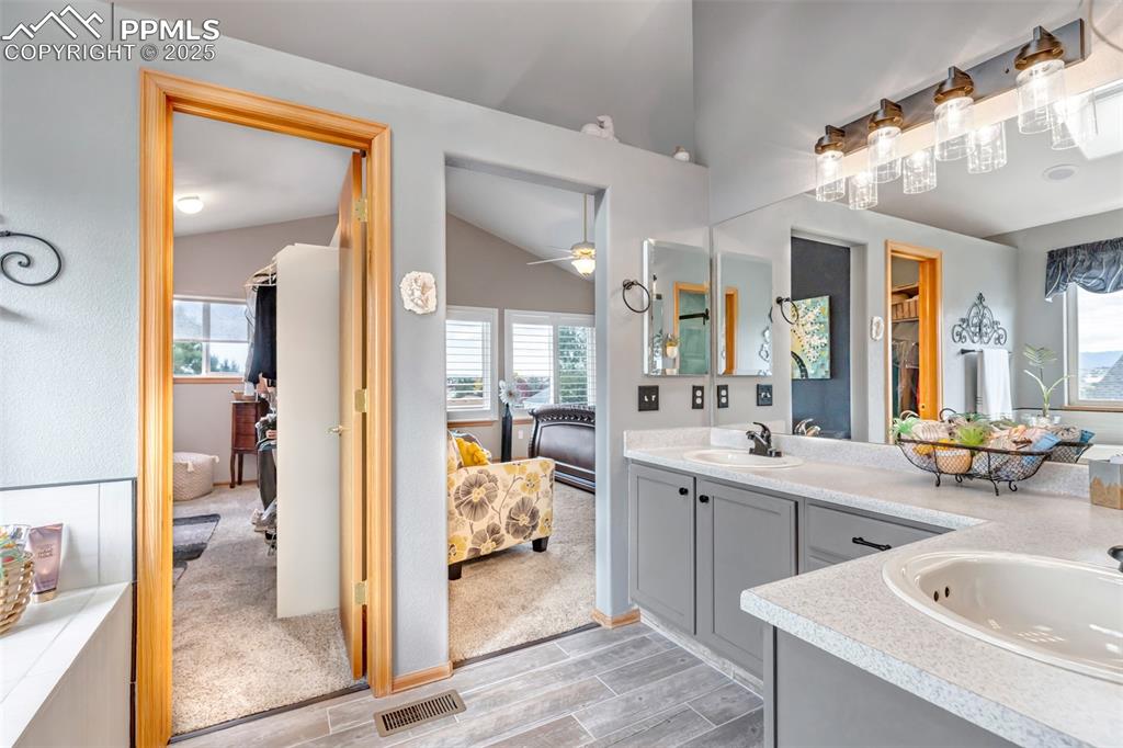7120 Highcroft Drive Colorado Springs, CO 80922 - Photo 29 of 50 a large bathroom with a tub sink shower and mirror