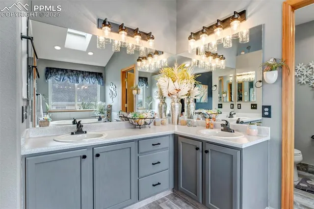 a bathroom with a sink vanity and a mirror
