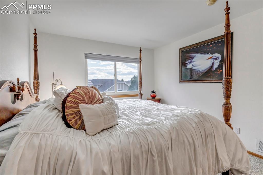 7120 Highcroft Drive Colorado Springs, CO 80922 - Photo 34 of 50 a bedroom with a bed and a couch