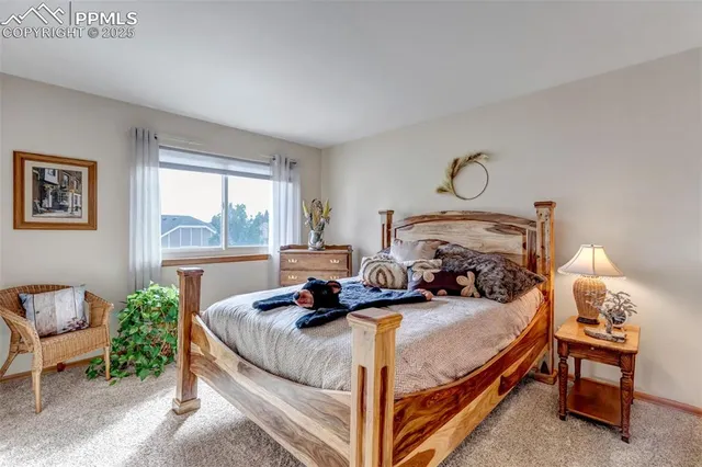 a bed room with a bed and a chair