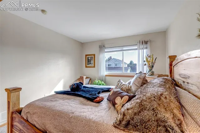 a bedroom with two beds and a large window