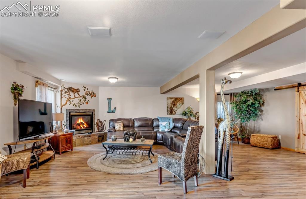 7120 Highcroft Drive Colorado Springs, CO 80922 - Photo 40 of 50 a living room with furniture a fireplace and a flat screen tv