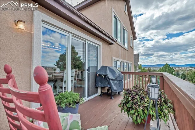a balcony view with a potted plant and outdoor seating