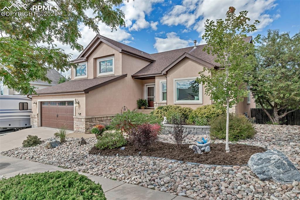 7120 Highcroft Drive Colorado Springs, CO 80922 - Photo 50 of 50 a front view of a house with garden