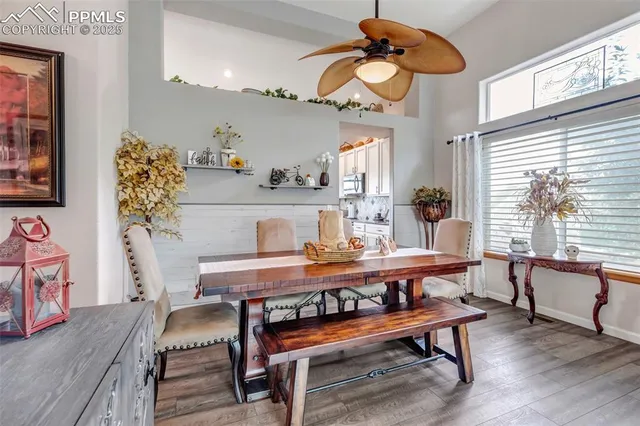 a view of a dining room with furniture window and wooden floor