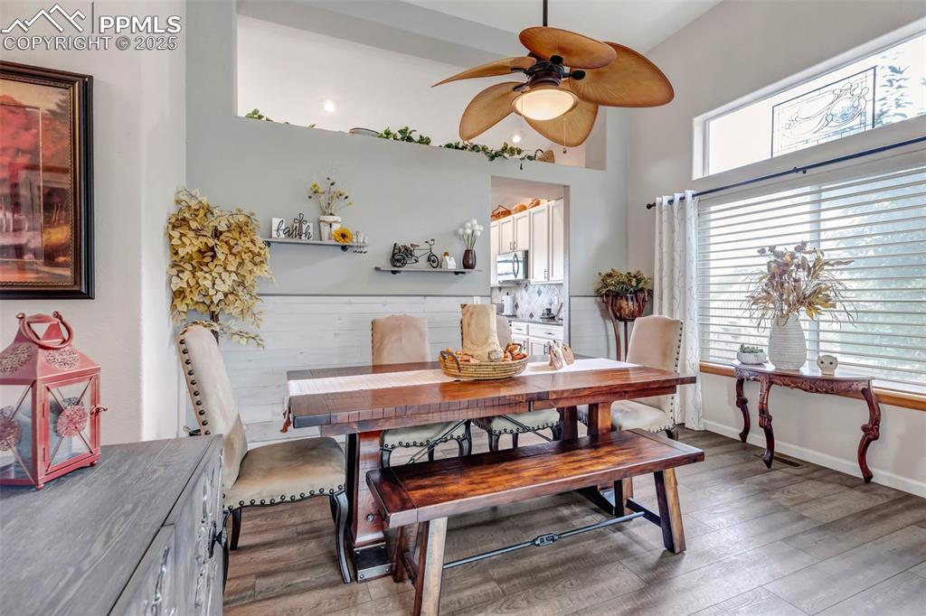 7120 Highcroft Drive Colorado Springs, CO 80922 - Photo 8 of 50 a view of a dining room with furniture window and wooden floor
