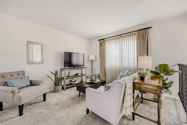 a living room with furniture and a window